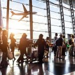 Riyadh Strike Sends Travelers Fleeing to Bahrain Passengers queue inside an airport terminal at sunset