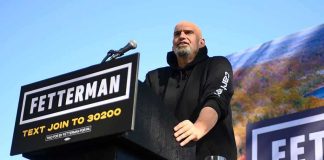 California Targets Homeless Camps by 2027 Speaker at outdoor podium with campaign signs