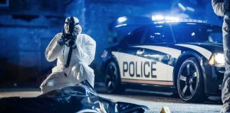 Philadelphia Officer Killed in Suspected Ambush forensic investigator photographing crime scene near police car