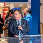 Tucker Carlson at a news desk in a busy studio setting