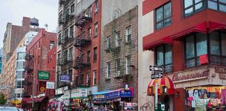 Hot-Liquid Attack Leaves Man Severely Burned City street with brick buildings, fire escapes, and busy storefronts