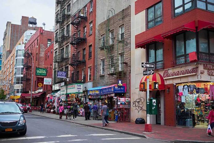 shutterstock_435935785 City street with brick buildings, fire escapes, and busy storefronts