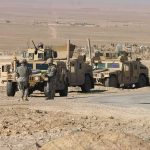 Egypt Weighs Yemen Conflict Role Soldiers near armored vehicles in a desert